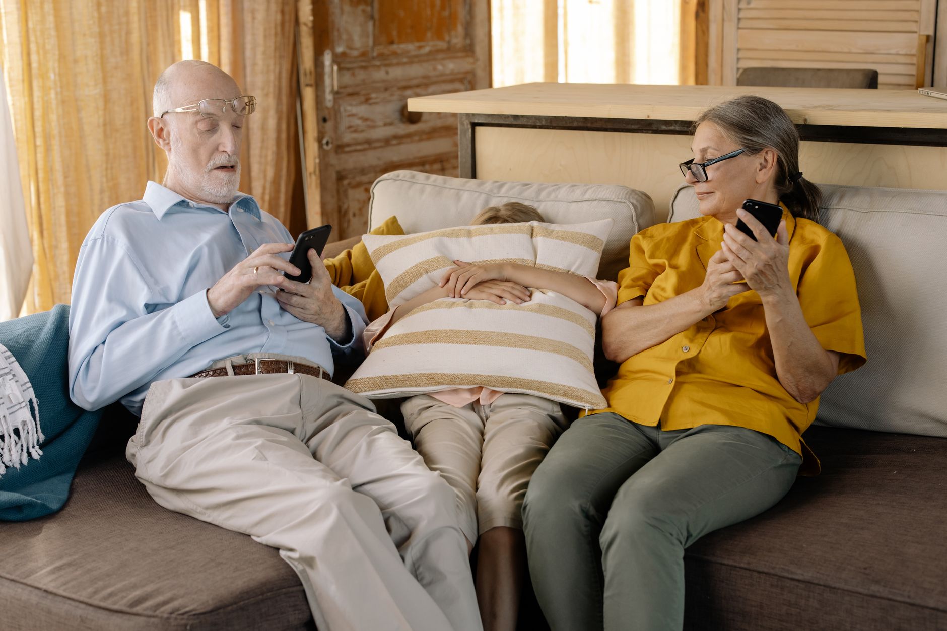 A carer and an older woman sitting together on a sofa